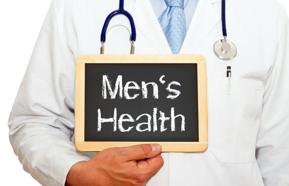 Male Doctor holding a blackboard saying Men's Health
